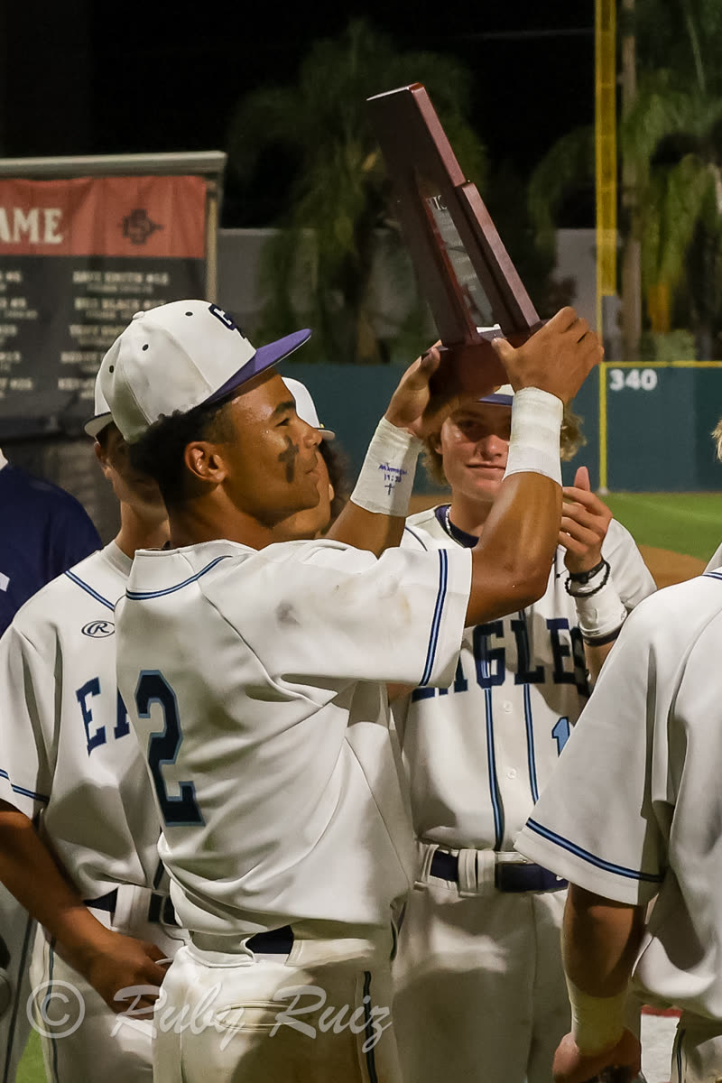 Brenden Lewis holding CIF Championship trophy